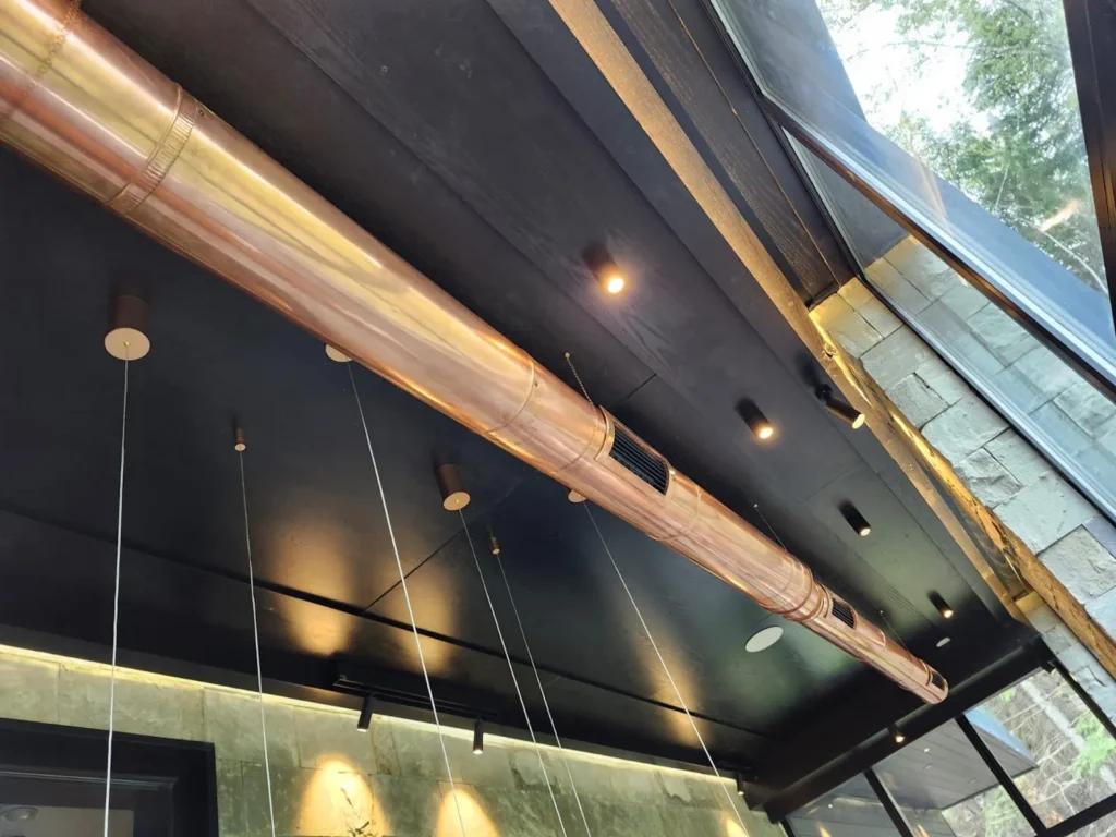 Exposed overhead pipes and ceiling surfaces in a commercial interior