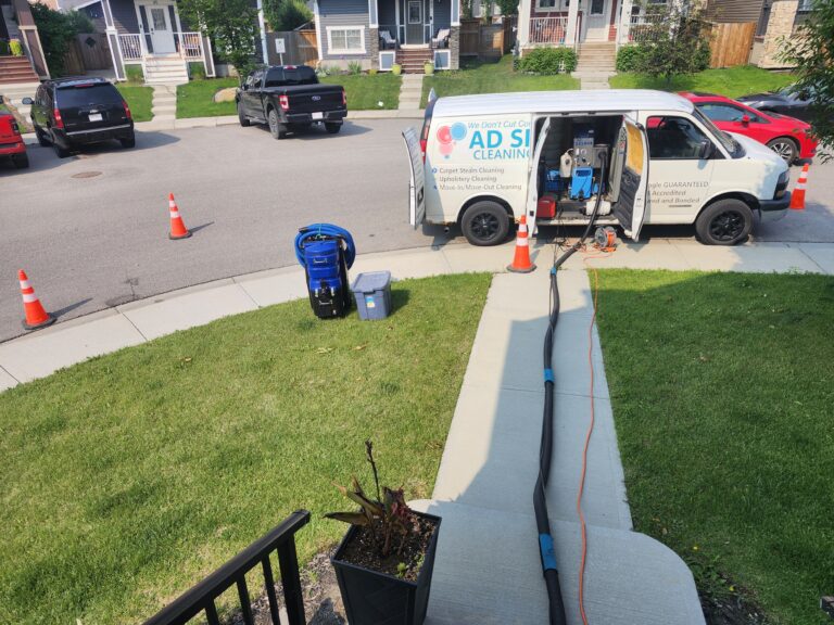AD Spotless carpet-cleaning van and hoses outside a home